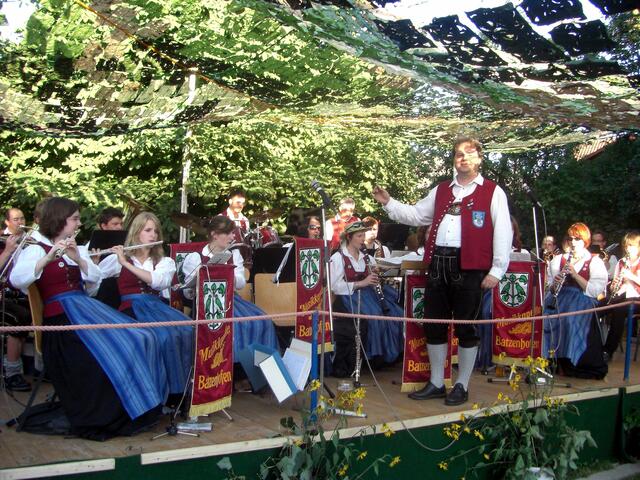 Musikkapelle Batzenhofen von einem Tarnnetz vor den Sonnenstrahlen geschützt