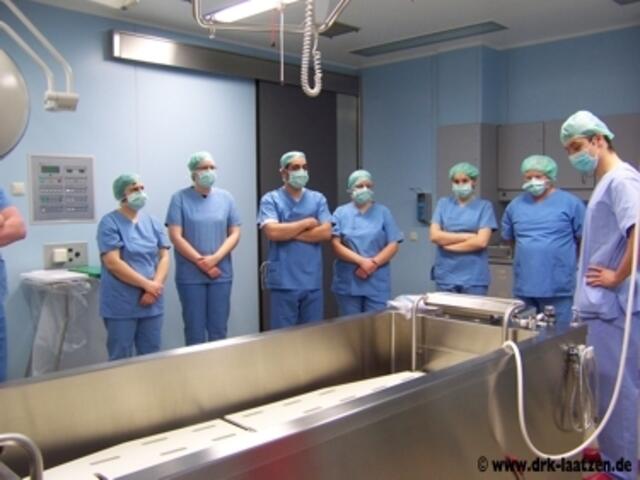 Dr. Herold (rechts) erklärt den DRKlern den Ablauf einer Patientenaufnahme in der Hydrotherapie