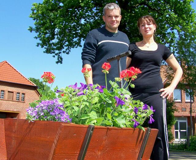 Violetta Nachtigall & Ralf Köhne vor Ihrem rot-blau gepflanzten Bollerwagen
