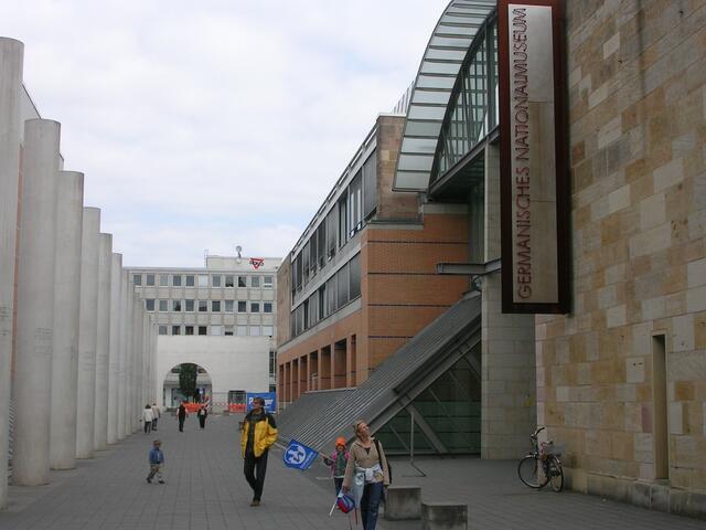 Germanisches Nationalmuseum und Straße der Menschenrechte. Das Werk besteht aus einem Tor und 27 Rundpfeilern aus weißem Beton sowie zwei Kopfplatten und einer Säuleneiche