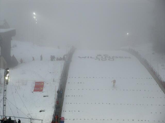 Die Schanze liegt voll im Nebel - nur noch die Scheinwerfer sind zu sehen.