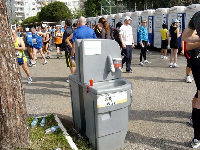 Eine mobile Waschstation vor den Kunststoff-Klohäuschen