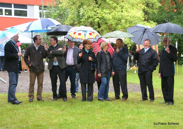 Nicht barfuß, aber im Regen: Die Vertreter vom Friedberger Stadtrat mit den Veranstaltern und Organisatoren bei der Eröffnung vom 9. Friedberger Sonnwend-Töpfermarkt