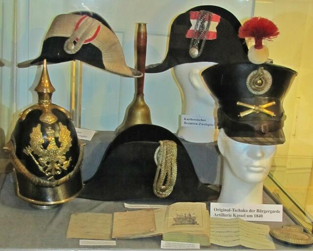 Rechts im Bild ist der Original-Tschako der Bürgergarde Artillerie Kassel um 1840 zu sehen.