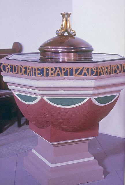 Taufstein von 1584 mit lateinischem Bibeltext, Abeckung von 1962 mit Fischsymbolen. Foto: Helmut Kuzina