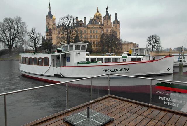 Das Fahrgastschiff "MS Mecklenburg" der Weißen Flotte an der Anlegestelle Werderstraße, im Hintergrund das Schloss