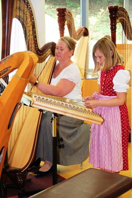 Ronja am Hackbrett mit ihrer Lehrerin Andrea Kratzer an der Harfe beim Konzert der Saitenmusik.