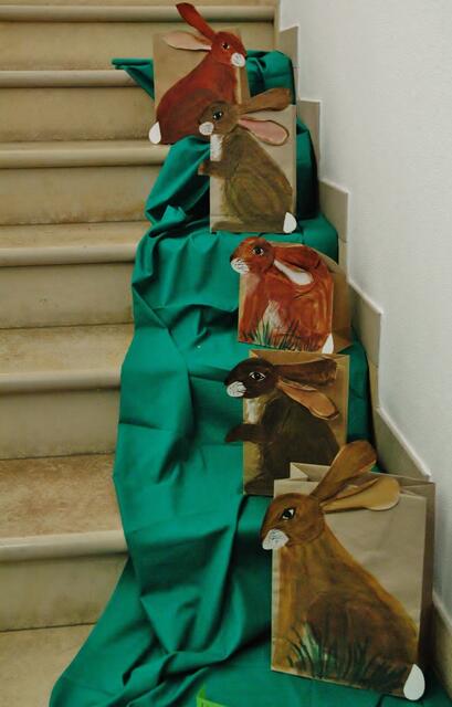 Osterhasen auf Papiertüten in Wartestellung.