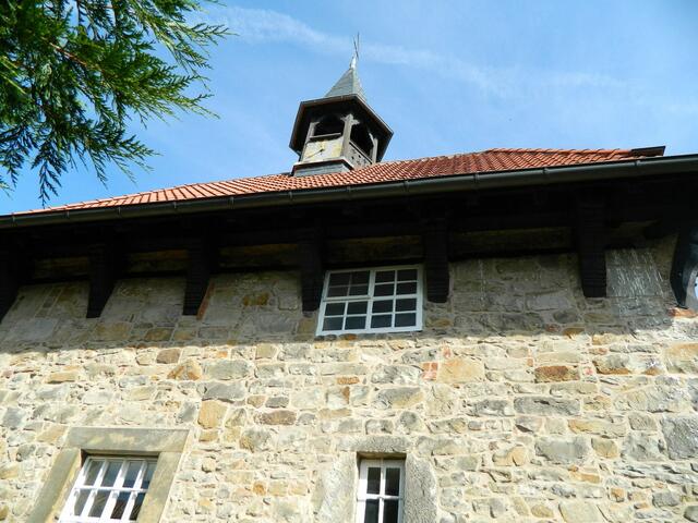 Der Steingiebel mit der Uhr und dem Glockenturm