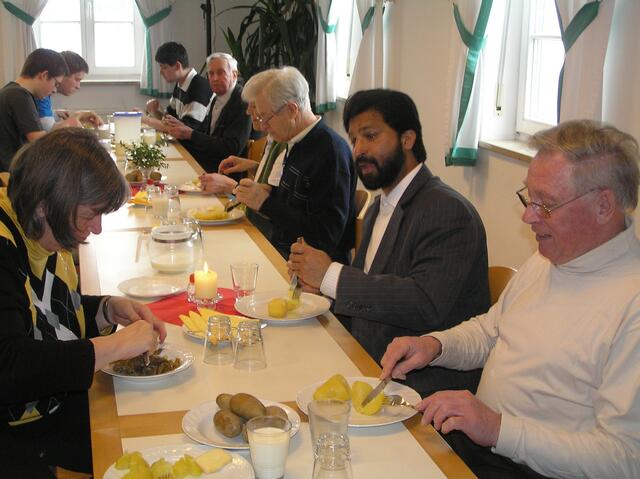 Präses Pfarrer Johnson Puthuva und Vorsitzender Franz Schaffer lassen sich die Kartoffeln schmecken.
