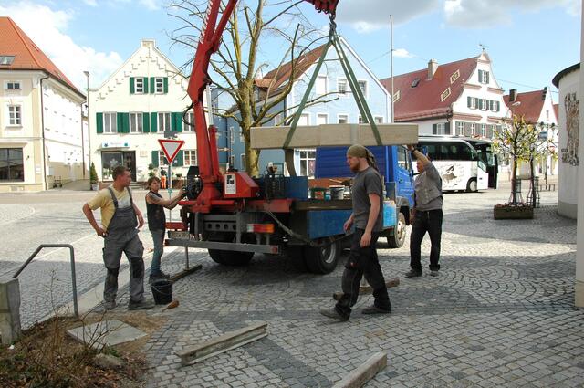 Links unten ist das Fundament für den Denkstein, der hier schon angeschwebt kommt.