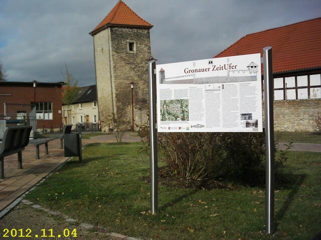 Gronau: Leinepromenade mit "Gronauer Zeitufer", gegenüber Südliche Leineinsel "Großer Kanian". Hinter dem Turm entstand 2016 in der weiterführenden Mühlenstraße der ebenfalls gemütliche "Leinebalkon" mit Sitzgelegenheiten.