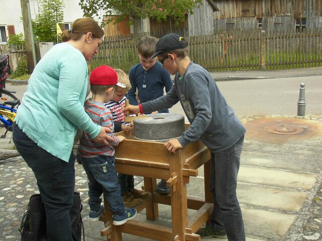 Besucher testen die Handmühle