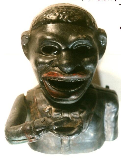 So sah man in der Kolonialzeit den hungrigen Bettler in Afrika: Steck eine Münze in die Hand, dreh an der Kurbel, die Figur verdreht die Augen bis ins Weiße und schluckt eine nach der anderen runter.