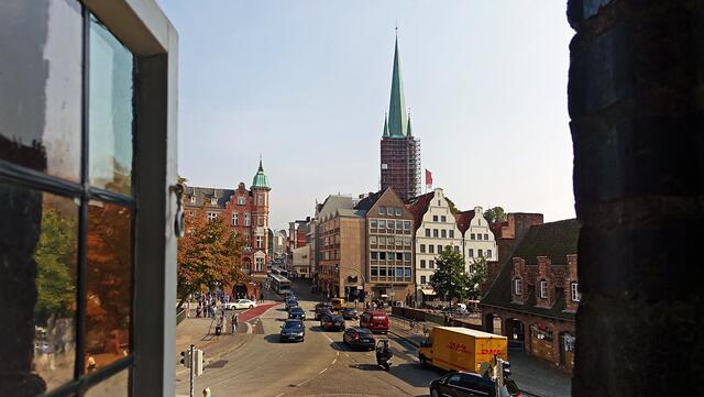 Im ersten Obergeschoss des Mittelbaus bringen sechs Fenster zur Stadtseite Licht in den Raum. Der Blick aus einem der Fenster geht in Richtung der Holstenstraße mit dem Turm der Petrikirche. Foto: Helmut Kuzina