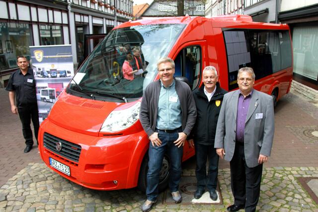 Bernd Hausmann, Jon Döring, Dietmar Vent(TS Fahrzeugtechnik GmbH) und Klaus Richard Behling stellen einen Bürgerbus in Osterodes Fußgängerzone einem breiten Publikum vor.