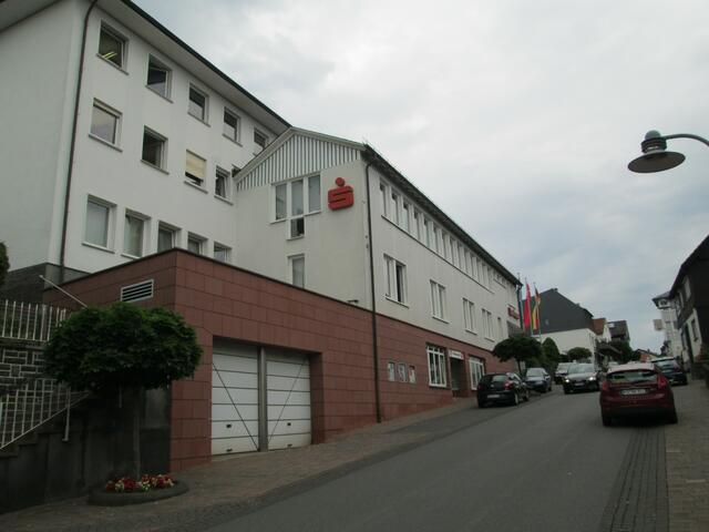 In der Hauptstraße geht oder fährt man aufwärts an der Sparkasse Battenberg vorbei.