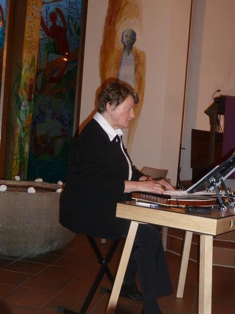 Im Hintergrund kann man das bunte Kirchenfenster erkennen.