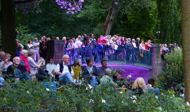 Wo auch immer der Blick auf die Bühne frei ist, haben sich Menschen niedergelassen.