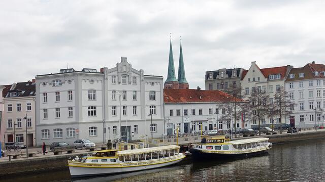 An der Schiffsanlegestelle der Obertrave, im Hintergrund die Doppelturmanlage des Domes. Foto: Helmut Kuzina