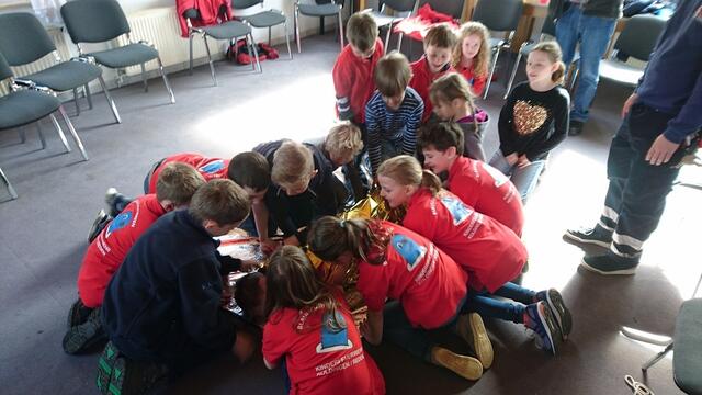 Gemeinsam haben wir es geschafft, den Verletzten einzuwickeln.