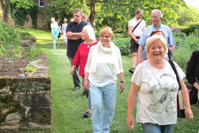 Beim Gartenrundgang. Maren Brechmacher-Ihnen (Mitte, mit weißem Schal) mit einigen Teilnehmern der Veranstaltung im Schlossgarten.