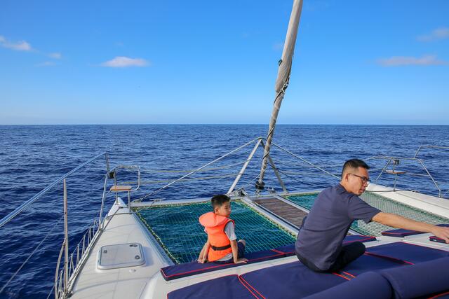 Vorn sind zwischen den beiden Rümpfen des Katamarans nur Netze als Boden. Auf dem Sitz, vorn, an der Spitze des Rumpfs, habe ich zum Fotografieren gesessen … luftig und manchmal etwas feucht :-)