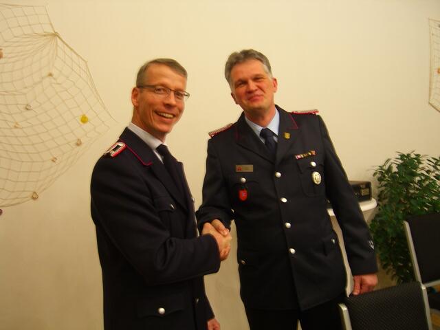 Carsten Kleuker (links) scheidet aus dem Kommando aus und wird von Ortsbrandmeister Oliver Jänsch mit einem Präsent bedacht.