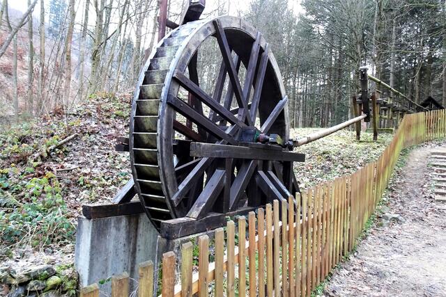 Modell einer Wasserkunst bei Hasserode (Archivbild).  Von oben wird dem oberschlächtigen Wasserrad Wasser zugeführt. Dadurch dreht sich das Rad. Durch das exzentrisch angebrachte Gestänge wird aus der rotierenden Bewegung eine lineare Bewegung. Über einen zweiseitigen Hebel werden in diesem Fall zwei Gestänge angetrieben.