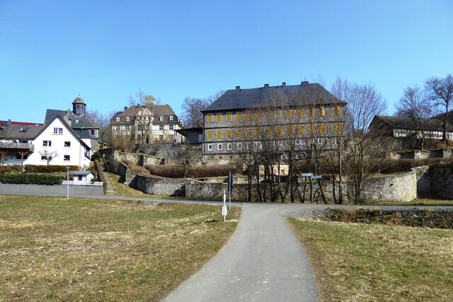 Kapelle sowie neues und altes Schloss der Familie von Breidenbach zu Breidenstein über den Resten der Ringwallmauern der weitgehend verfallenen Burg.