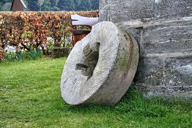 ein historischer Mahlstein an der Mühle