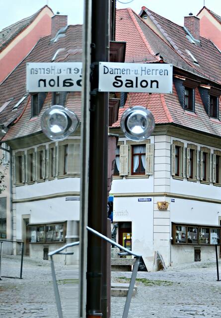 Im Frisörladen spiegeln sich die Häuser von Dettelbach