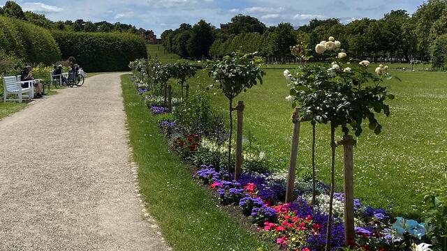 Viele Spaziergänger verweilen auf den Bänken der Gartenanlage, um sich am Ausblick auf die bunten Blumenbeete zu erfreuen. Foto: Helmut Kuzina