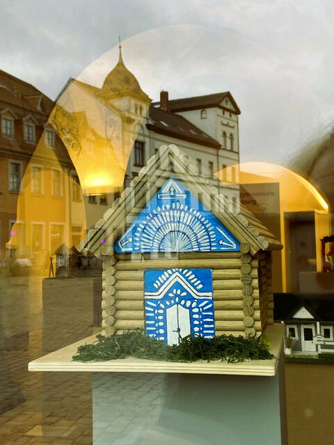 Sibirische Blockhütte, von draußen durch die Scheibe fotografiert. 