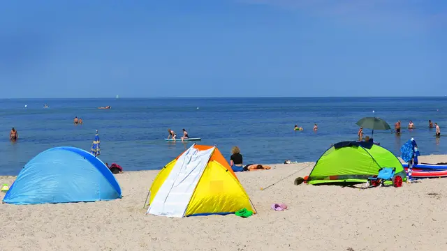 Abseits vom Strandkorbbereich gibt es bunten Sonnen- und Windschutz. Foto: Helmut Kuzina