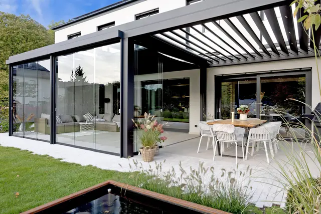 Eine Vielzahl an Kombinationen ist möglich: Auf diesem Bild etwa schließt an das Glashaus ein Freisitzbereich mit schließbarem Lamellendach an. | Foto: DJD/Bundesverband Wintergarten e.V.