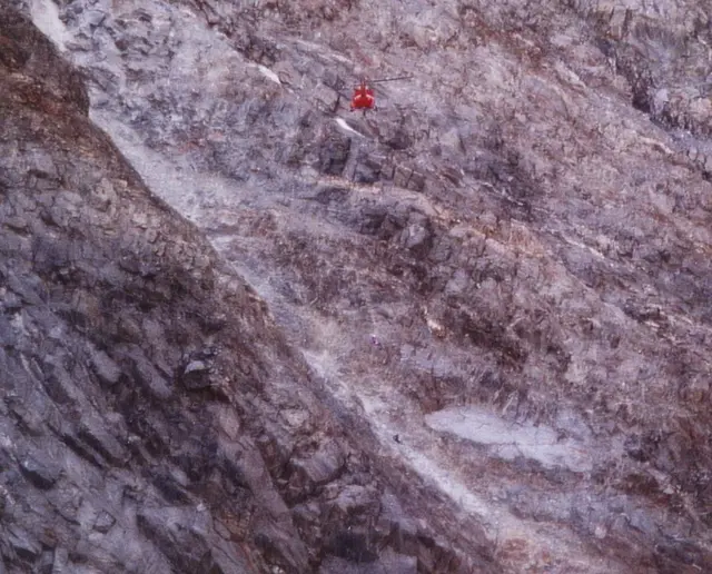 Ein Retter der Bergwacht seilt sich im berüchtigten Grand Colouir am Montblanc zu einem Toten ab, der durch Felssturz ums Leben gekommen ist. Der Tote sitzt in der Rinne. Seinen Sturz zwischen Felsbrocken konnten wir über eine Fallstrecke von 600 Metern Tiefe beobachten. Wir waren geschockt. Fels- und Gletscherabbrüche haben wir nicht selten selbst erlebt.  | Foto: Kurt Wolter