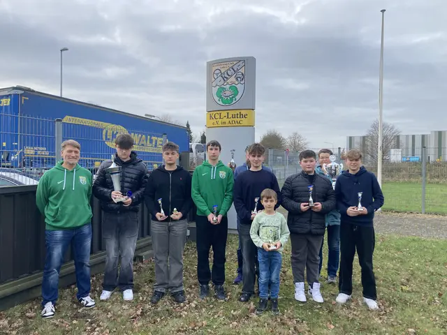 Die geehrten Kinder und Jugendlichen präsentieren ihre Pokale vor dem Clubcenter. Mit dabei: Trainer Sascha Rustler