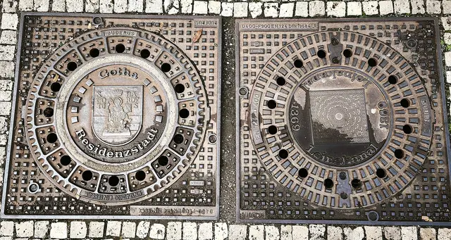 Kanaldeckelduo an der Wasserkunst: Links das Wappen von Gotha, das auch als Mosaik den Marktplatz ziert. | Foto: Shima Mahi