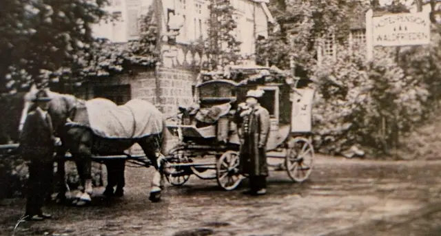 Die Postkutsche von Biedenkopf macht vor dem Hotel Waldfrieden ca. 1910 in Hatzfeld Rast.