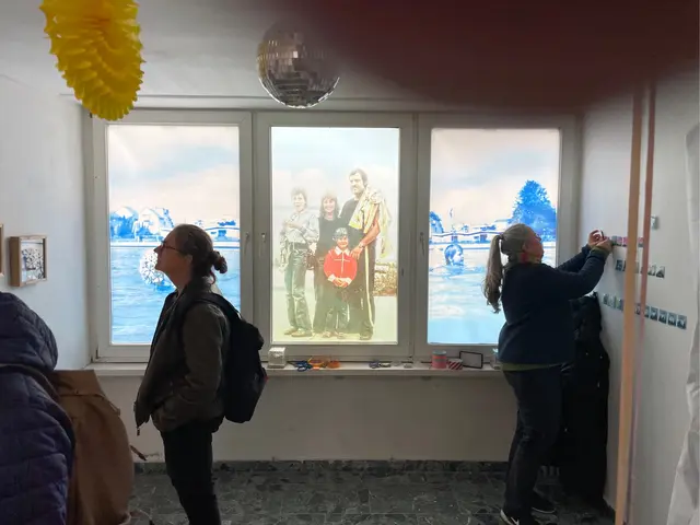 Transparente Erinnerungen auf den Fensterscheiben im Erdgeschoss des Ludwigturms im Duisburger Innenhafen. Rechts im Bild die Künstlerin Ute Nowak bei der Hängung ihrer vielseitigen Miniaturen. | Foto: Andreas Ingramm, AIRL-Lab KKRR