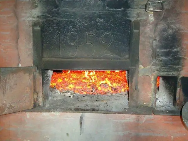 Der Backofen wird mit Buchenholz angeheizt