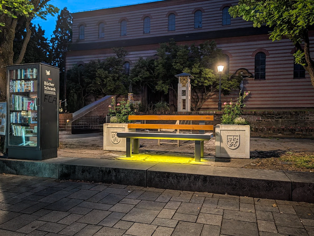 Solarbank für innovative Gemütlichkeit - Die erste Solarsitzbank in Friedberg/Bayern ist mit der Unterstützung von MItarbeitern des städt, Friedberger Bauhofs am Bücherschrank in der Ludwigstraße in Betrieb genommen worden. Smartphone Laden, USB-Anschlüsse und Internet-Zugang nutzen - oder einfach eine Shopping-Pause einlegen. Auch in den Abendstunden ist die Solarsitzbank ein willkommener Hingucker | Foto: FSeventfoto
