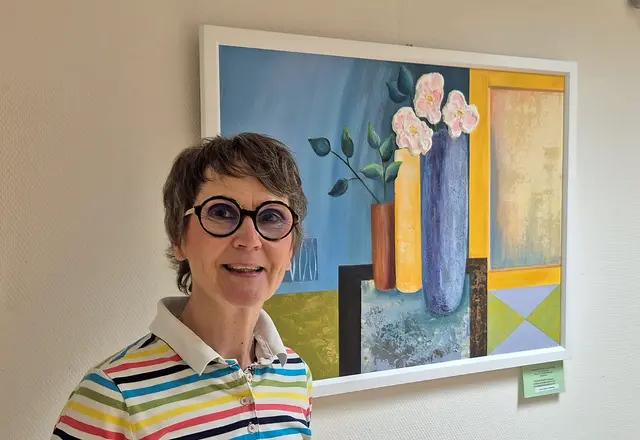 Christine Radtke-Schramm vor ihrem Bild „Sommerfrische zu Hause“, welches zusammen mit weiteren Blumenbildern aktuell im Krankenhaus Friedberg zu sehen ist. 
 | Foto: Kliniken an der Paar / Kathrin Ruf