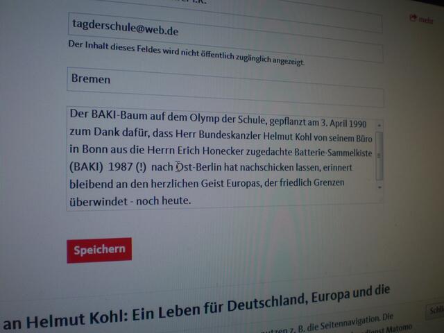 "Der BAKI-Baum auf dem Olymp der Schule. gepflanzt am 3. April 1990, zum Dank dafür. dass Herr Bundeskanzler Helmut Kohl von seinem Büro in Bonn aus die Herrn Erich Honecker zugedachte Batterie-Sammelkiste (BAKI) 1987 (!) nach Ost-Berlin hat nachschicken lassen, erinnert bleibend an den herzlichen Geist Europas, der friedlich Grenzen überwindet - noch heute."