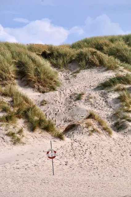 Dünen, Sand und ein Rettungsring am Henne Strand